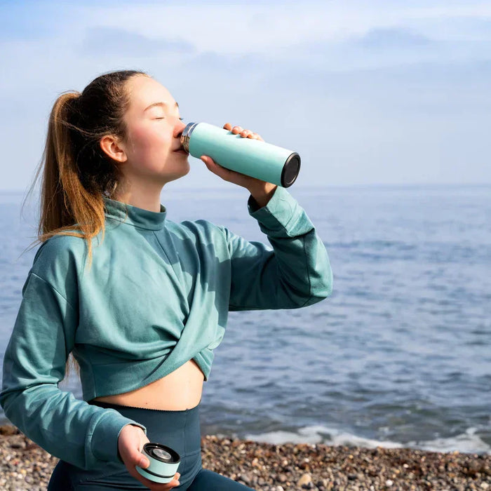 woman drinking hydrating electrolyte drink
