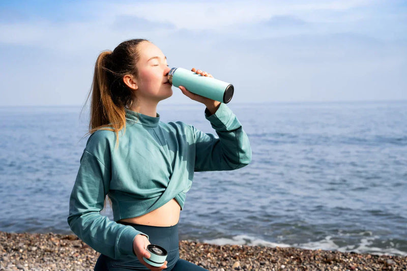 woman drinking hydrating electrolyte drink