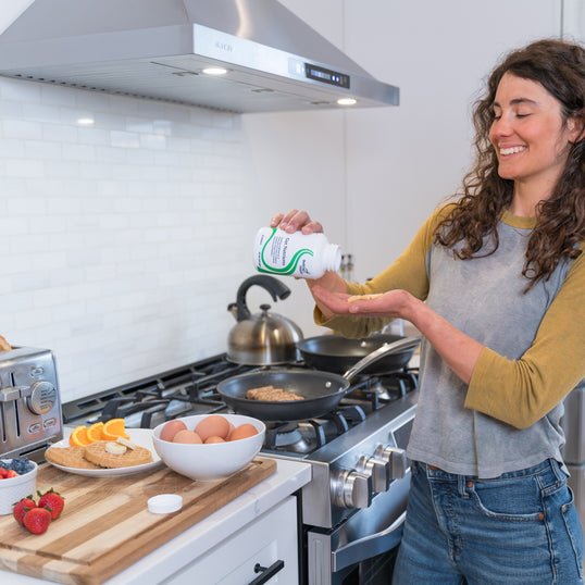 image of woman pouring capsules in hand