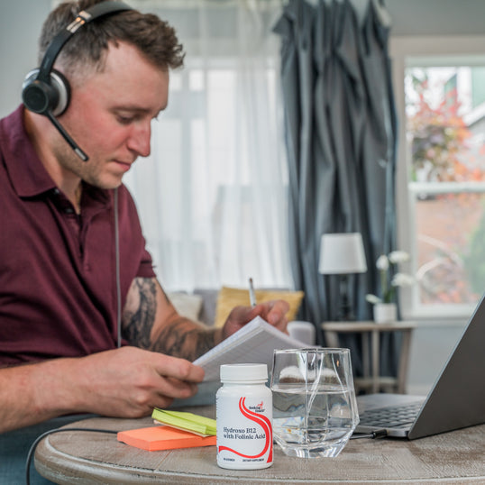 image of man working at desk with headset on 