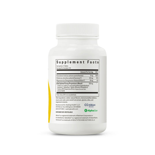 A white plastic bottle of supplement powder shown from the back, featuring a white cap and a detailed black supplement facts label with green and blue brand logos.