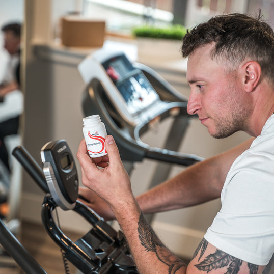 Image of man looking at product while on treadmill 