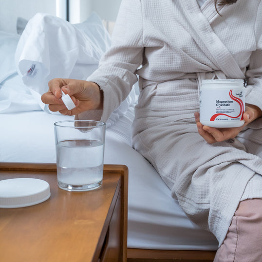 Image of person adding Magnesium Glycinate to water 