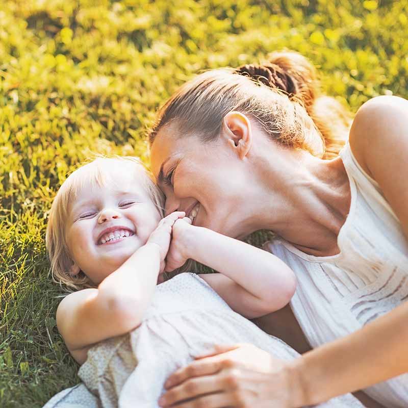 A woman and her daughter laughing