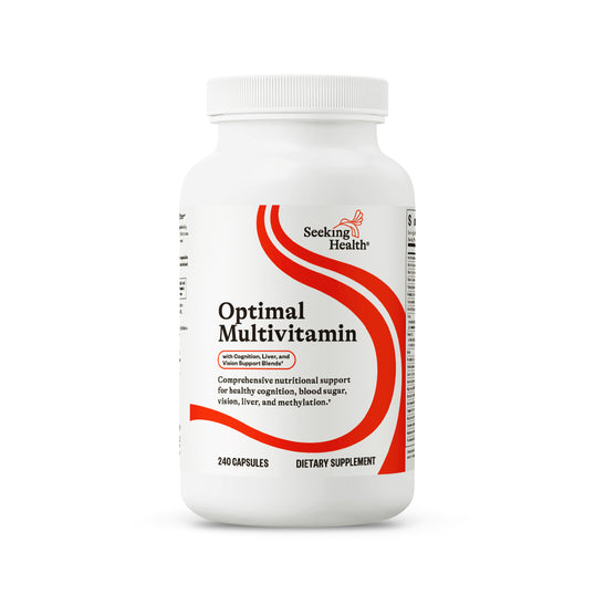 A white bottle of Seeking Health Optimal Multivitamin dietary supplement with a white cap, featuring a red and black label on a clean white background.