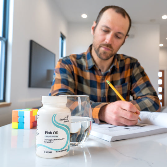 Image of man writing at desk 