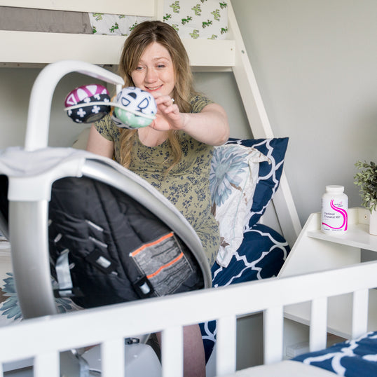 A mom preparing a nursery with Optimal Prenatal MF
